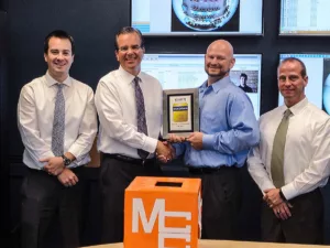 About mcc - awards - security solutions salespeople accepting an award from chris throckmorton of exacvision