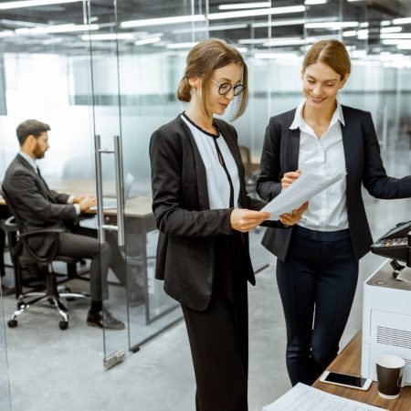 Business people near the copier in the hallway