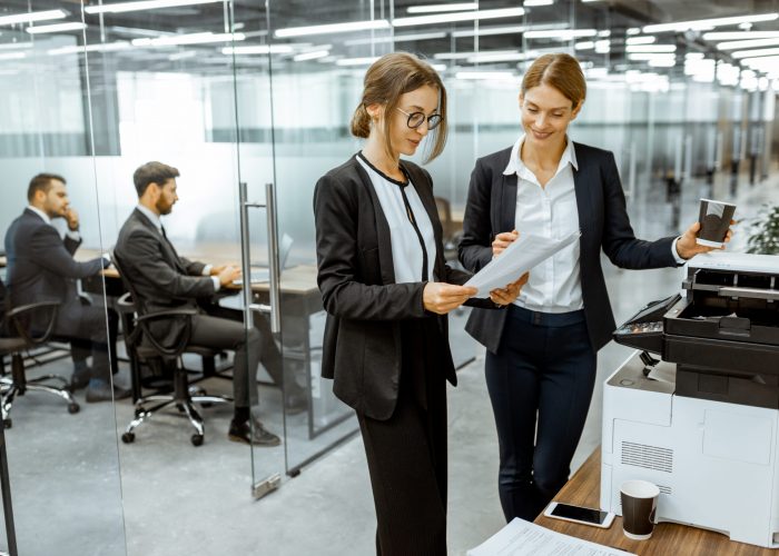 Business people near the copier in the hallway