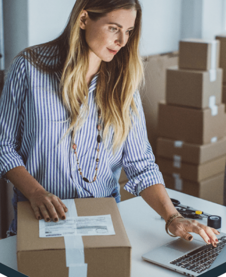 Business woman shipping packages using MCC Office Technology Solutions and mailing and shipping software