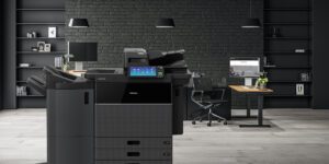 Toshiba estudio 7516ac copier in an office with black walls and modern desks.